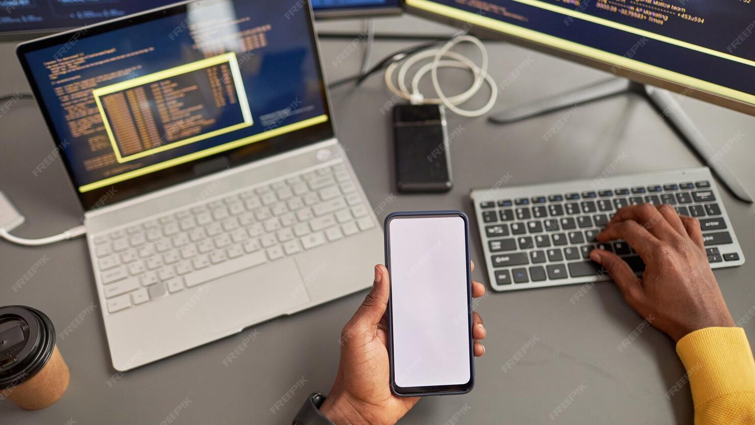 Top view unrecognizable black man holding smartphone mockup writing code 236854